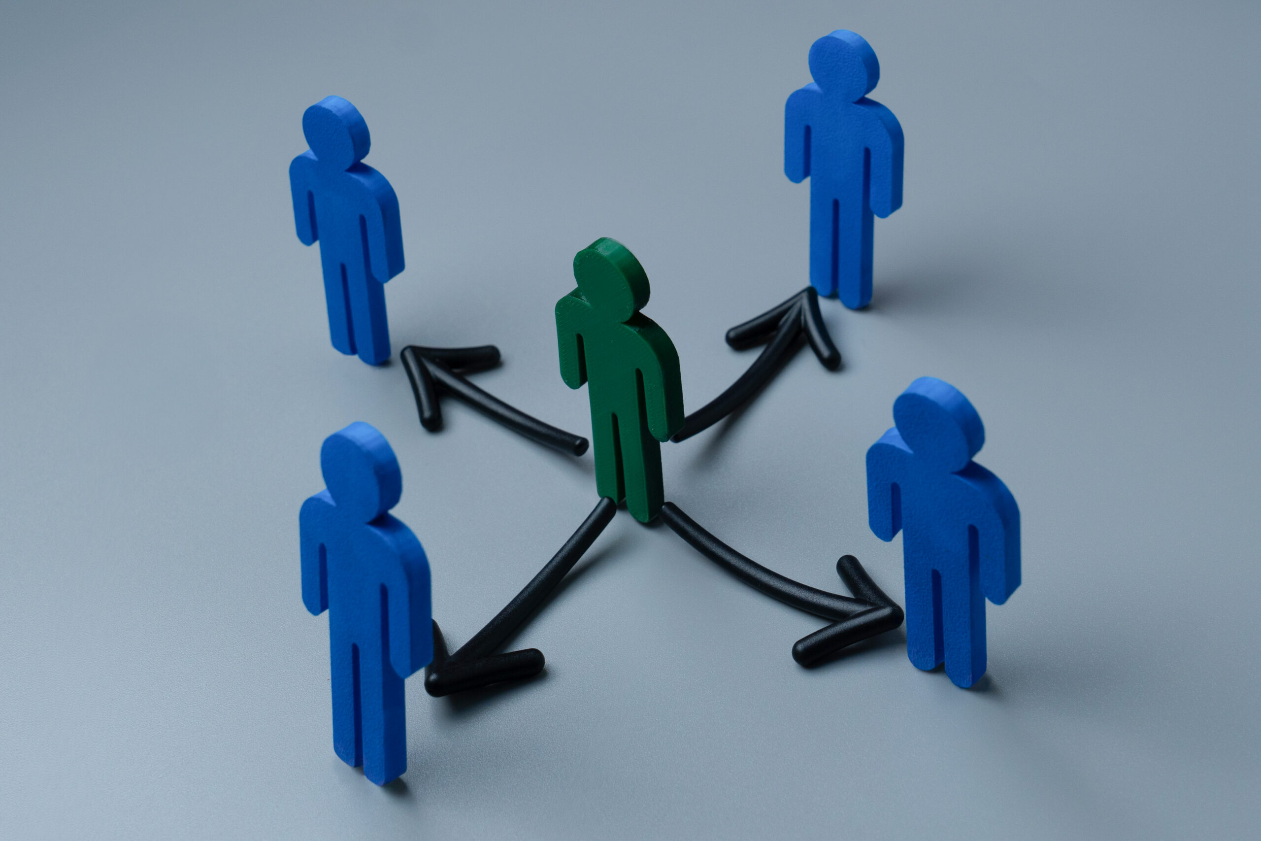 A green figure trying to build brand awareness with blue figures