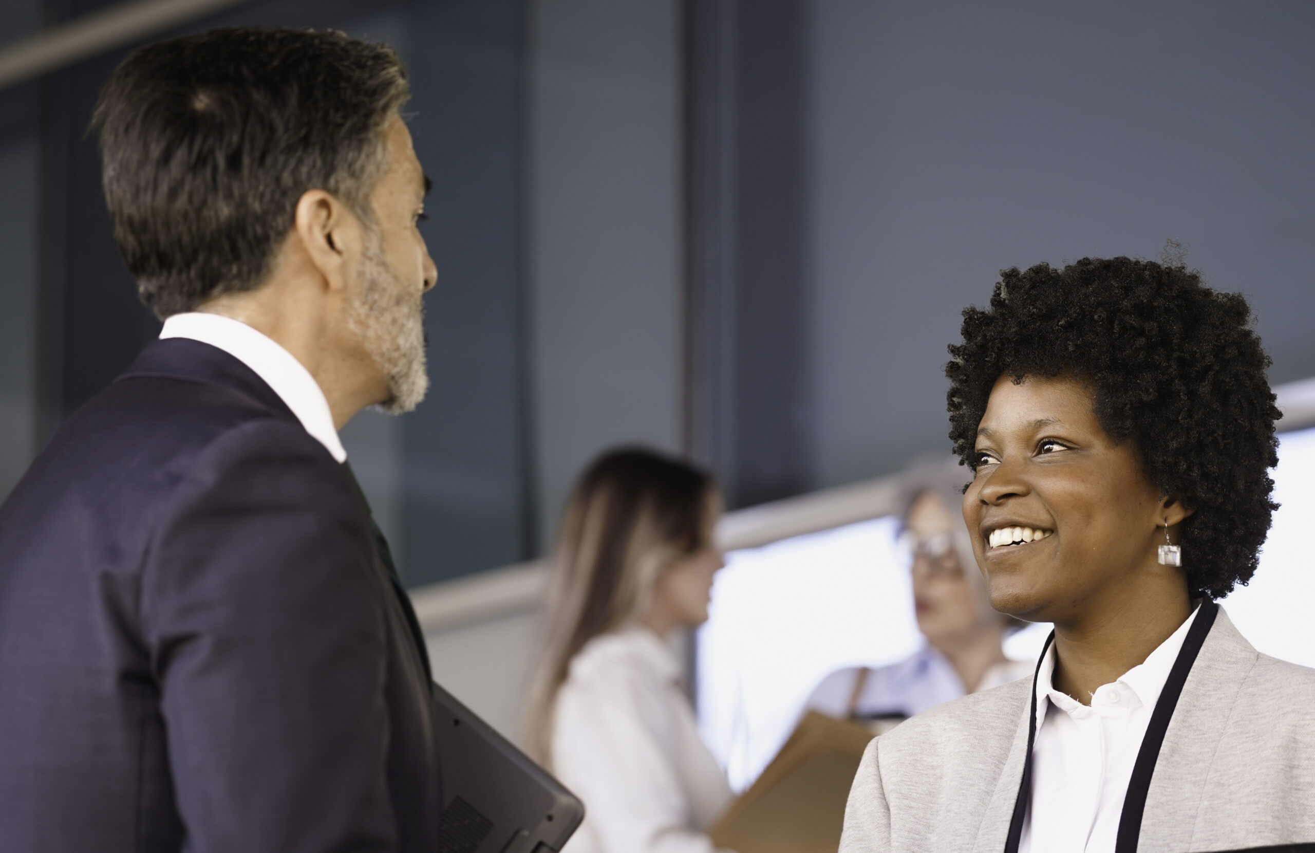 A leadership and management trainer talking to a colleague face-to-face